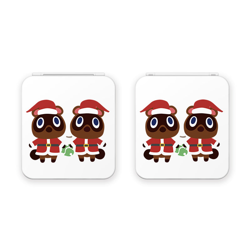 Two cartoon raccoons named Timmy and Tommy, dressed in red Santa hats and red holiday jackets, stand side by side holding wrapped gifts. This festive image of the raccoons is repeated twice on the white background of the petimint Timmy & Tommy Christmas Game Card Box for Nintendo Switch. Perfect for adding a touch of holiday spirit to any cozygamer's décor.