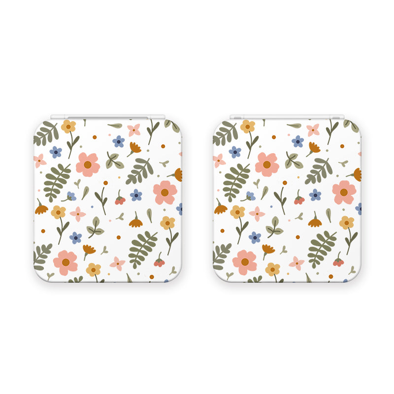 The petimint Spring Game Card Box for Nintendo Switch comes in white and features a delicate floral pattern with pink, orange, and blue flowers, along with green leaves and fern-like plants scattered across the surface. These small, square-shaped boxes have rounded corners and are perfect for adding a touch of charm to any cozygamer’s setup.