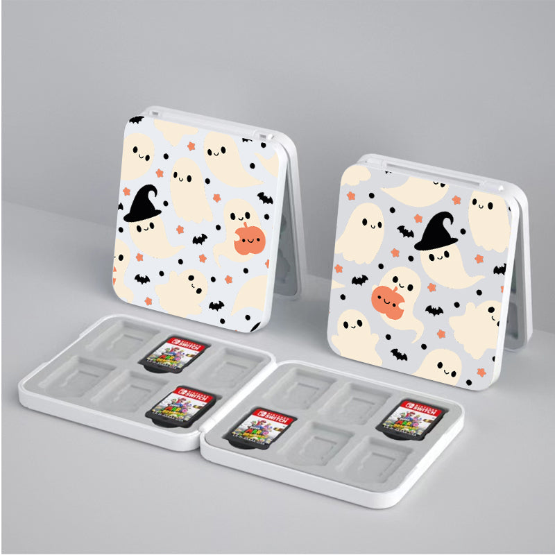 Two Spooky Ghost Game Card Boxes for Nintendo Switch by petimint, showcasing Halloween-themed designs with cute ghosts, bats, and pumpkins. Each box contains slots for Nintendo Switch game cartridges—ideal for any gamer—with one slot in each box displaying a game card. The boxes are set on a light gray surface.