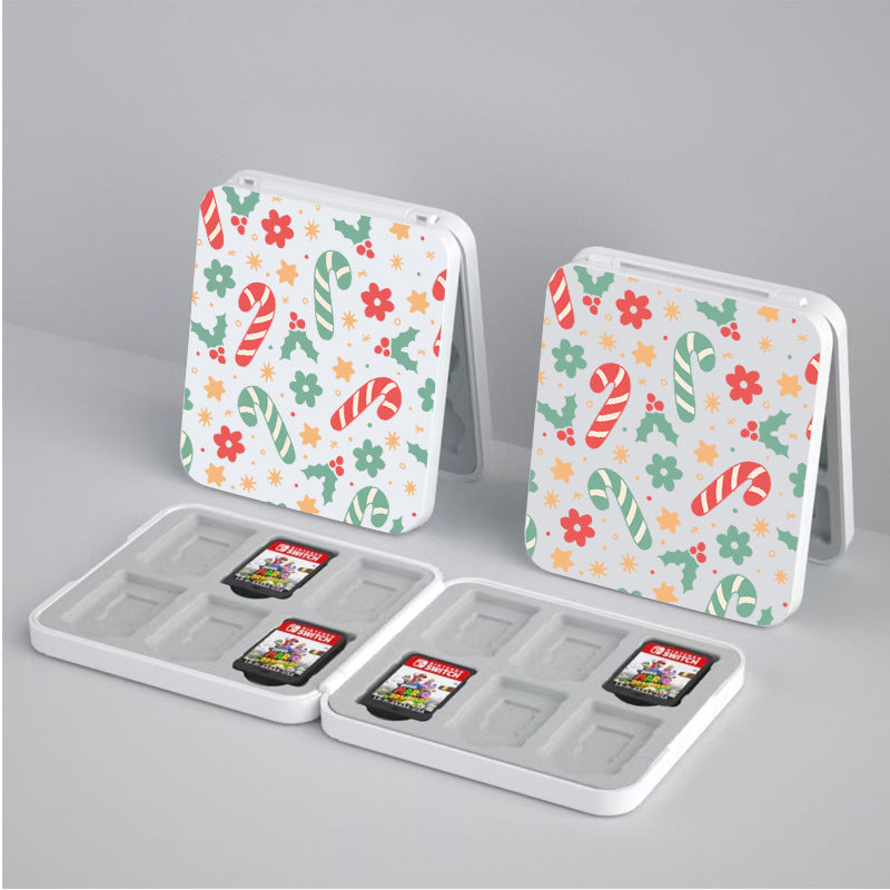 Two open petimint Candy Cane Game Card Boxes for Nintendo Switch, each featuring a colorful pattern of candy canes and flowers. One compartment in each box holds four Nintendo Switch game cartridges. The boxes are set against a plain gray background.
