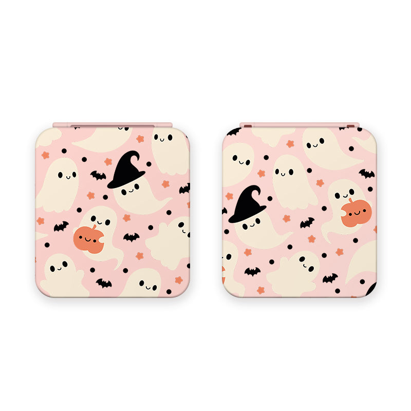 Two Spooky Ghost Game Card Boxes for Nintendo Switch from petimint, are designed in pink square compacts featuring illustrations of cute white ghosts, black bats, orange pumpkins, and stars. Some of the ghosts wear black witch hats, and one holds a pumpkin. The overall design is playful and Halloween-themed—perfect for any gamer looking to add a festive touch to their setup.