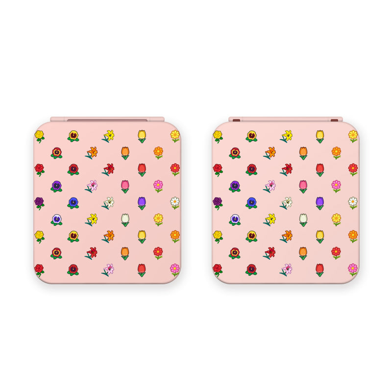 Two pink Flower Crossing Game Card Boxes for Nintendo Switch by petimint are placed side by side. Both boxes feature a playful pattern of small, colorful flowers and leaves scattered across their surfaces, adding a whimsical touch to the design. Perfect for any cozygamer who loves adorable and practical accessories. The background is white.