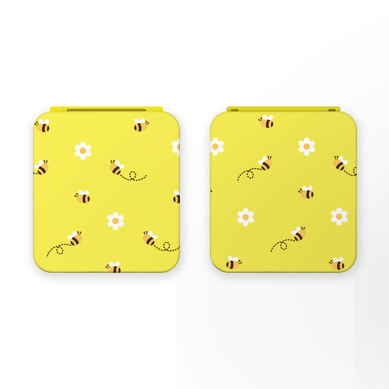 Two petimint Little Bee Game Card Boxes for Nintendo Switch are shown side by side. Each yellow case features a charming design of bees, white flowers, and dotted lines representing bee flight paths, making them perfect for accessorizing your Nintendo Switch gaming setup.