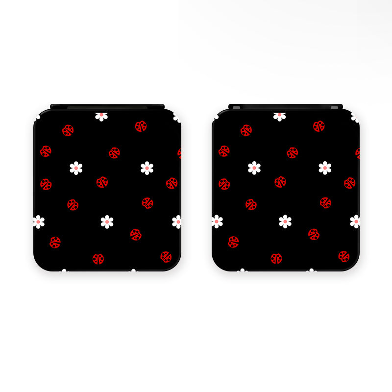 Two Little Ladybug Game Card Boxes for Nintendo Switch by petimint, showcasing a black background with small red ladybugs and white flowers. Perfect for the cozygamer, these charming designs bring an extra touch of allure to your Nintendo Switch setup. Displayed side-by-side, these boxes are as functional as they are cute.