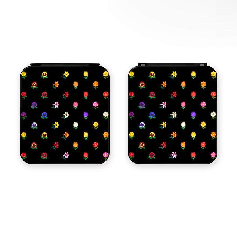 Two compact square mirrors, each featuring a black background adorned with vibrant and varied colorful flowers, create an ideal addition to the cozygamer setup. Displayed side by side, these mirrors showcase an eye-catching floral design reminiscent of the aesthetic found in petimint's Flower Crossing Game Card Box for Nintendo Switch.