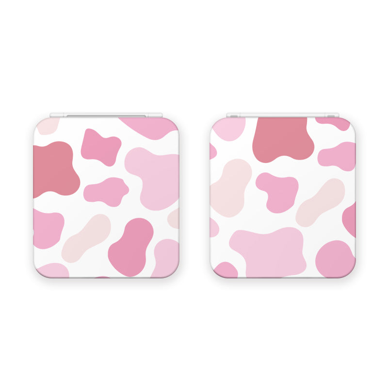 Two Strawberry Cow Game Card Boxes for Nintendo Switch by petimint, featuring a charming pastel cow print pattern. The design showcases irregular pink spots of varying shades on a white background. Perfect for the cozygamer aesthetic, the card boxes are displayed closed, side by side.