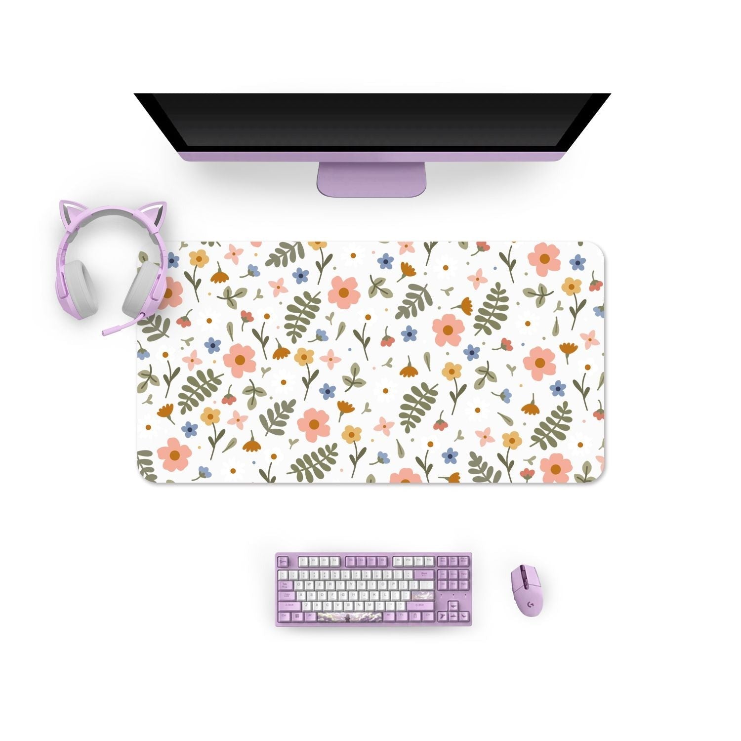 A computer monitor sits on a desk alongside the petimint Spring Mouse Pads PC Gaming Accessories, showcasing a vibrant floral pattern with pink, orange, and blue flowers. A pair of cat ear headphones rests on the corner of the mouse pad. A purple keyboard and matching mouse complete this cozy gamer’s perfect setup.
