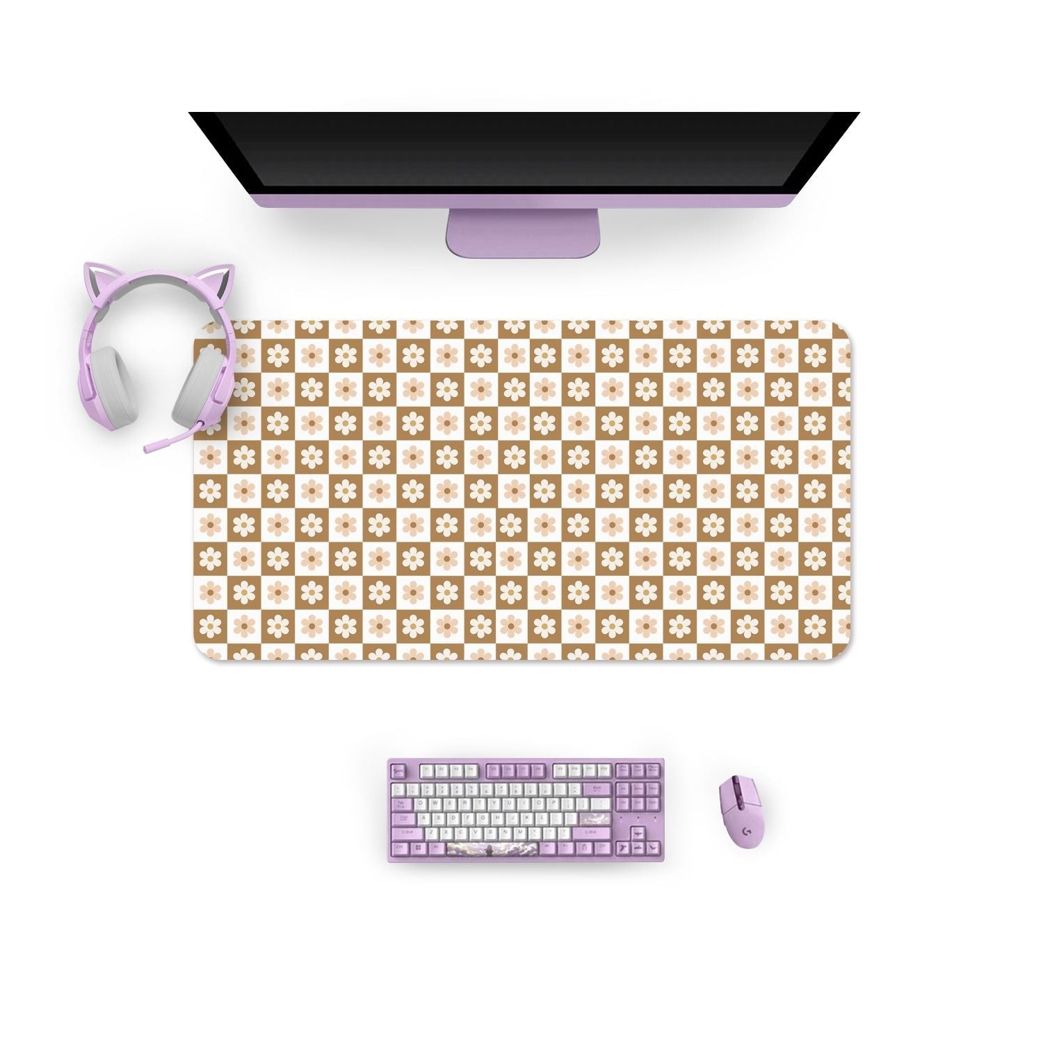 Top-down view of a desk setup featuring a computer monitor, keyboard, mouse, and cat ear headphones, all in pastel lavender. The large Cozy Checkered Flowers Mouse Pad from petimint showcases a cute cartoon pattern on beige and white floral cloth and rubber. The desk setup maintains a cohesive lavender and floral theme.