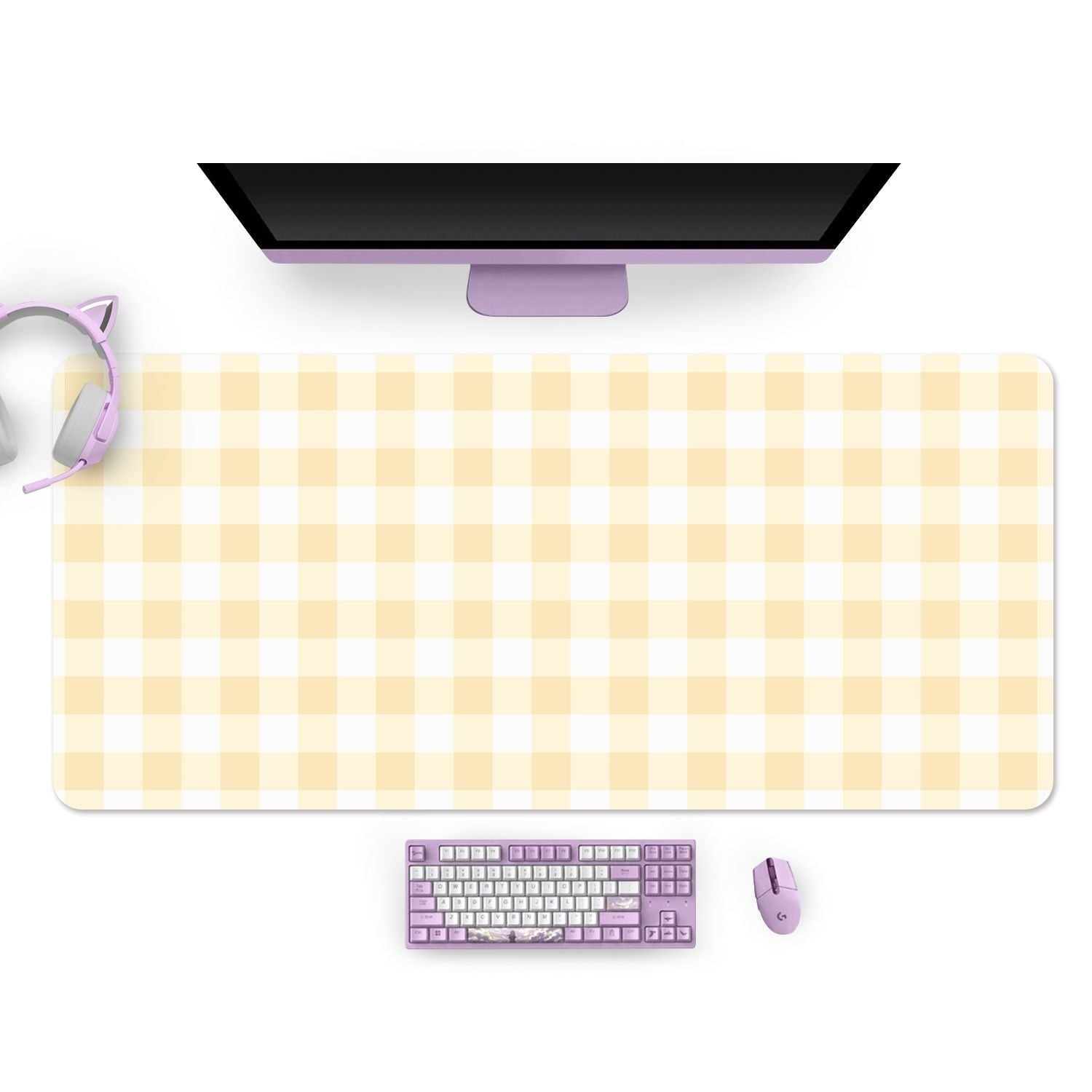 Top-down view of a desktop setup featuring a wide yellow picnic-style desk mat from petimint. On the mat, there's a sleek monitor, a keyboard, a mouse, and a pair of cat ear headphones—all in pastel shades of purple. Perfectly set for gamer aesthetics, it's ready for your next gaming session with the Picnic Mouse Pads PC Gaming Accessories.
