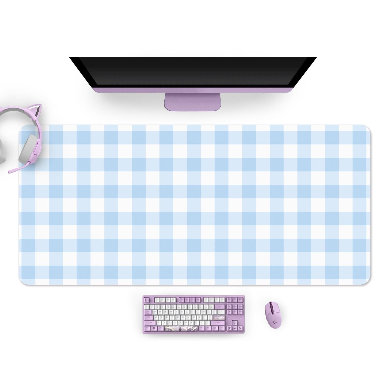 A gamer's computer desk setup featuring the Picnic Mouse Pads PC Gaming Accessories from petimint, in a large blue design. On the mouse pad, there is a purple keyboard and a matching purple mouse. A purple monitor adorned with cat-ear headphones on its left side completes this setup, making it ideal for a Nintendo Switch owner.