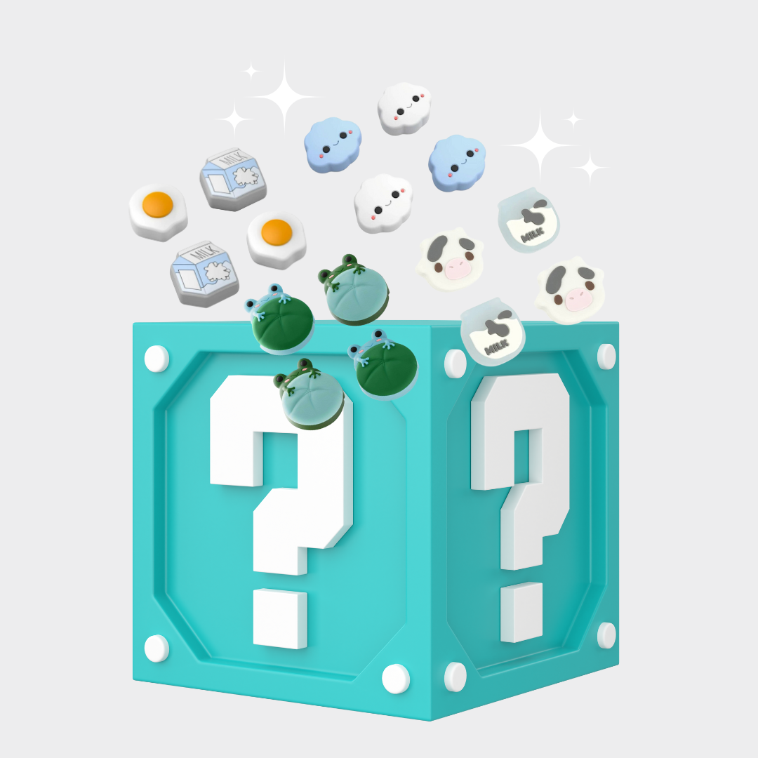 A teal "Mystery Box Thumb Grips" by petimint, adorned with white question marks, is surrounded by playful 3D icons including cows, green frogs, blue clouds, eggs, and milk cartons against a light gray background. Sparkles dance above the box, adding a whimsical touch.
