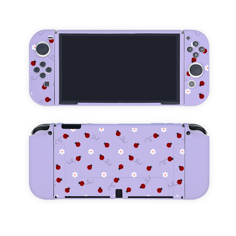 Introducing the Little Ladybug Case for Nintendo Switch by petimint: This lavender case is adorned with a charming pattern of red ladybugs and white flowers. The delightful theme covers both the Joy-Con controllers and the back of the console, bringing a playful, nature-inspired touch to any gamer's collection. Perfect for those seeking unique and stylish gaming accessories.
