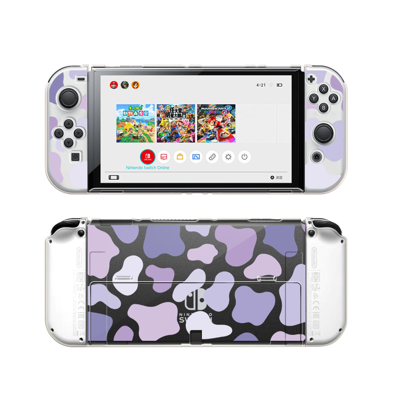 A Nintendo Switch console is presented with a Lilac Cow Case from petimint, showcasing a unique purple and white camouflage design. The front view displays game icons on the home screen, ideal for any gamer, while the back view accentuates the full camouflage pattern on the clear casing.
