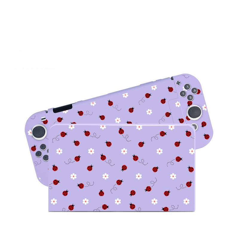 The Little Ladybug Case for Nintendo Switch by petimint is a delightful pastel purple cover featuring an enchanting design of red ladybugs and white daisies. Ideal for any gamer, this decorative case enhances both the main body of the console and the attached controllers.