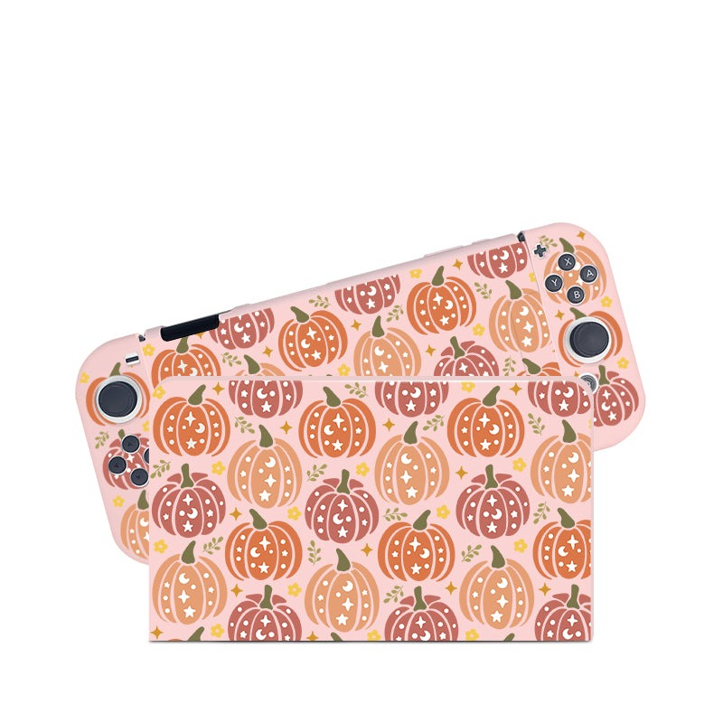A close-up image of two Nintendo Switch devices encased in the Pumpkins Case by petimint, showcasing a festive design perfect for any cozypgamer. The case features a pattern of orange, pink, and beige pumpkins adorned with stars and leaves against a pink background. With buttons and joysticks on the sides, these devices are ideal additions to any gamer’s collection.