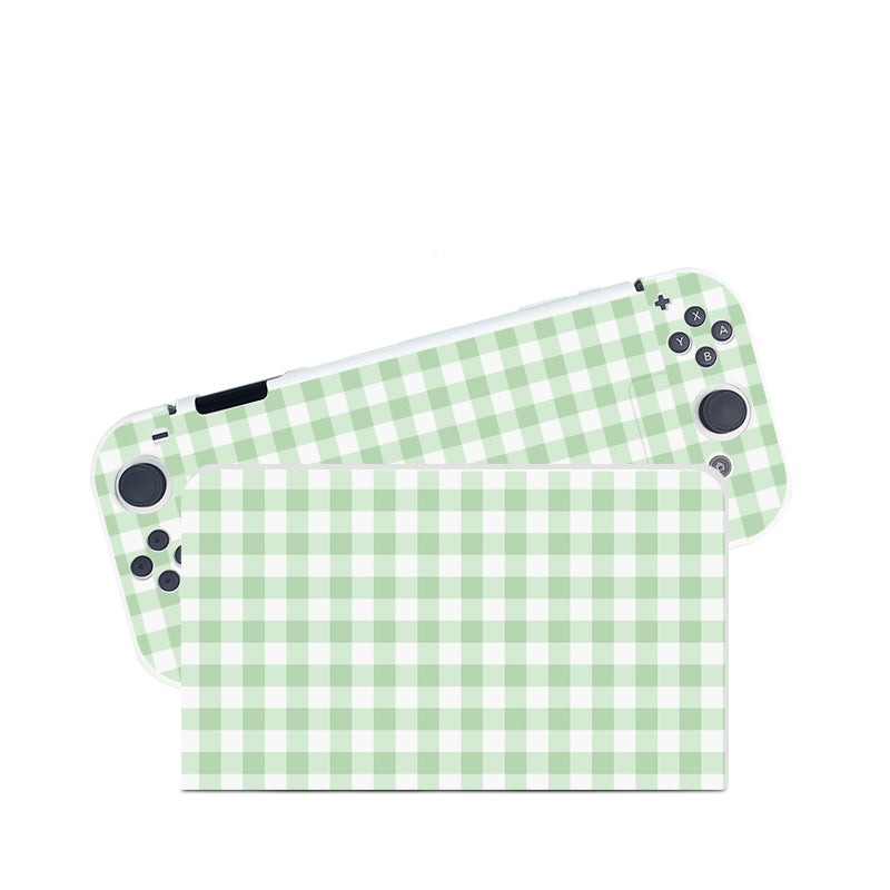 A Picnic Case for Nintendo Switch by petimint, adorned with a light green and white checkered pattern, reminiscent of a handheld gaming console. The case is displayed diagonally, showcasing both the front screen and back cover. The buttons and joystick controls are clearly visible on the front side.