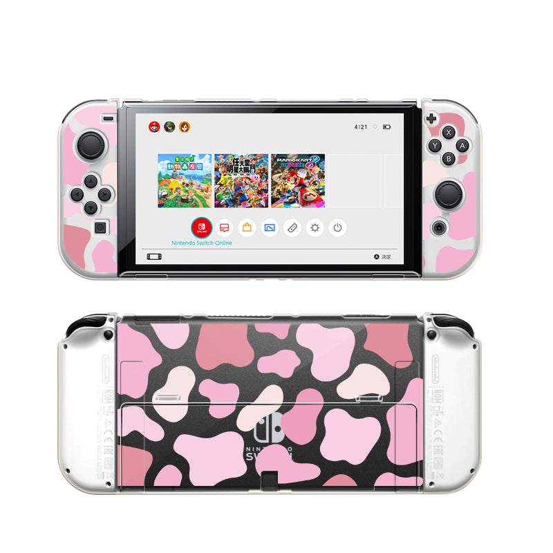 A Nintendo Switch featuring the Strawberry Cow Case from petimint, which showcases a pink and black camouflage design on the Joy-Con controllers, complemented by a soft TPU grip case. The screen displays a menu with four games visible, while the back of the Switch is adorned with the same camouflage pattern.