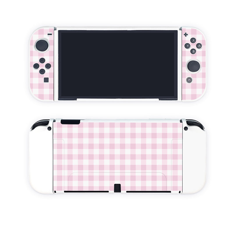A Picnic Case for Nintendo Switch from petimint, featuring a pink gingham pattern. The image showcases both the front and back of the console, highlighting the patterned surface on the detachable controllers and back panel. The blank black screen makes it perfect for any gamer looking to stylize their setup.