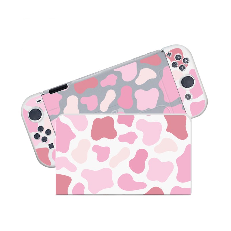Introducing the Strawberry Cow Case for Nintendo Switch by petimint—a light pink and white gaming console case with abstract shapes adorning the controllers and dock. It features a dockable design that beautifully showcases various shades of pink and white in an irregular, spotted pattern, making it ideal for a stylish setup.