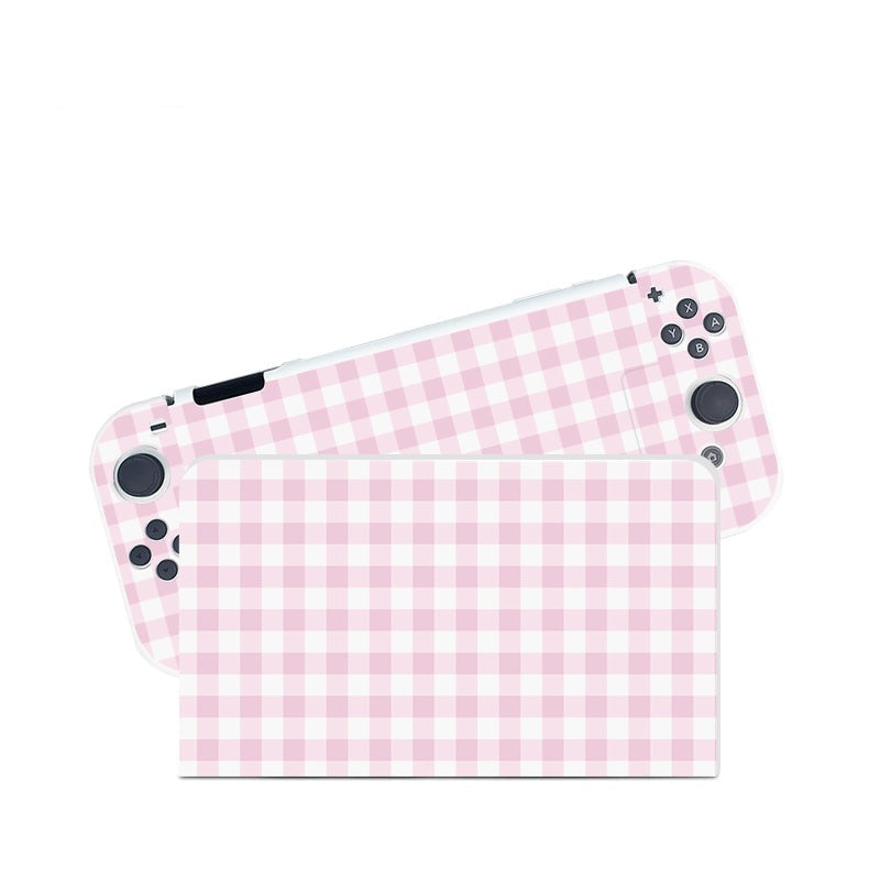 Introducing the Picnic Case for Nintendo Switch by petimint, a stylish handheld gaming console adorned with a charming pink and white checkered design. Perfect for the cozygamer, this device features a screen and detachable controllers on the sides, each boasting the same delightful pattern. The image showcases a front view of this trendy device with the controllers partially separated.