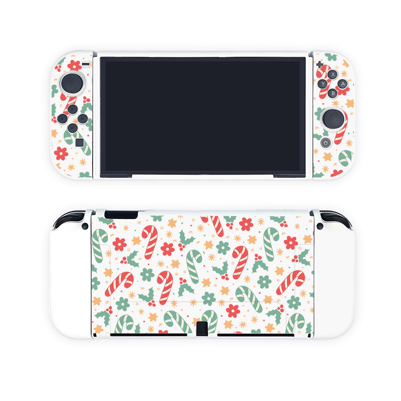 The Candy Cane Case for Nintendo Switch by petimint is a white handheld gaming console case featuring a festive holiday-themed design. The front showcases white grips, black buttons, and multicolored motifs, ideal for the cozy gamer. The back is decorated with a vibrant pattern of candy canes, Christmas trees, and flowers in cheerful red, green, and yellow hues.