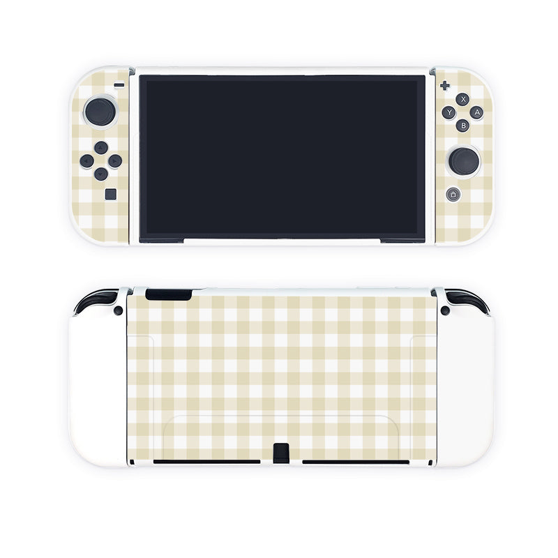 Introducing the Picnic Case for Nintendo Switch by petimint, featuring a chic beige and white checkered pattern on both its front and back surfaces, reminiscent of fashionable clothing. The screen remains blank, but the design integrates standard control buttons and joysticks, making it ideal for any stylish gamer.