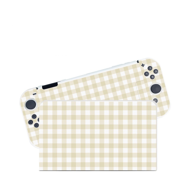 The petimint Picnic Case for Nintendo Switch is the perfect fit for any cozygamer, featuring a charming beige and white checkered design on both the screen cover and the detachable controllers. This case comes equipped with various buttons and joysticks typical for gaming.