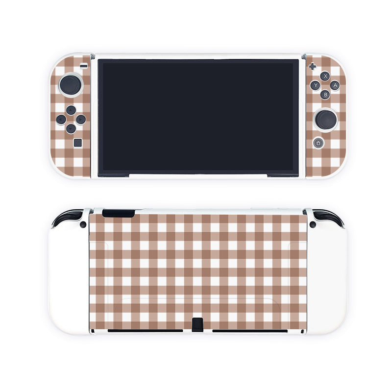 Picture a Nintendo Switch nestled in the Picnic Case by petimint, featuring detachable controllers adorned with a brown and white checkered pattern covering both the front and back. The main screen of the Switch is turned off, and the entire back of the console showcases the same charming checkered design, giving off a custom vibe perfect for gamers who appreciate unique aesthetics.