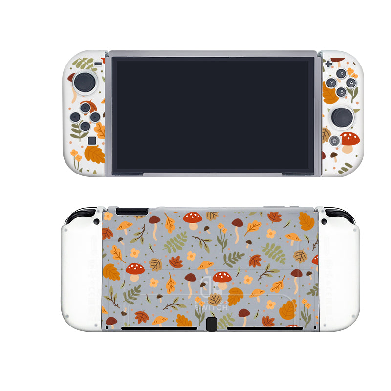 The Cozy Autumn Case for Nintendo Switch by petimint is a handheld gaming console accessory showcasing a nature-themed design adorned with colorful leaves, mushrooms, and acorns against a gray background. This whimsical design decorates both the front of the console and the back of its detachable controllers. Additionally, it includes a semi-clear Dockable Case made from soft TPU for enhanced protection.