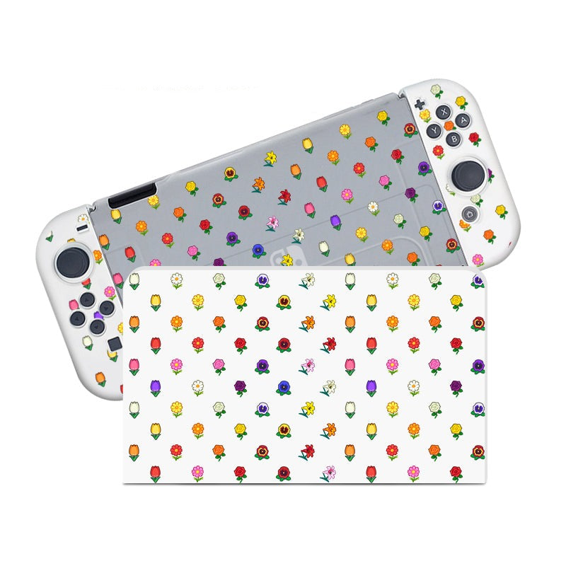 The Flower Crossing Case for Nintendo Switch by petimint is a gaming console case with a white body and floral-patterned joysticks and buttons, perfect for the cozy gamer. The multicolored floral designs feature various flower types scattered across the device. A close-up of the backside reveals a transparent case also adorned with similar floral patterns.