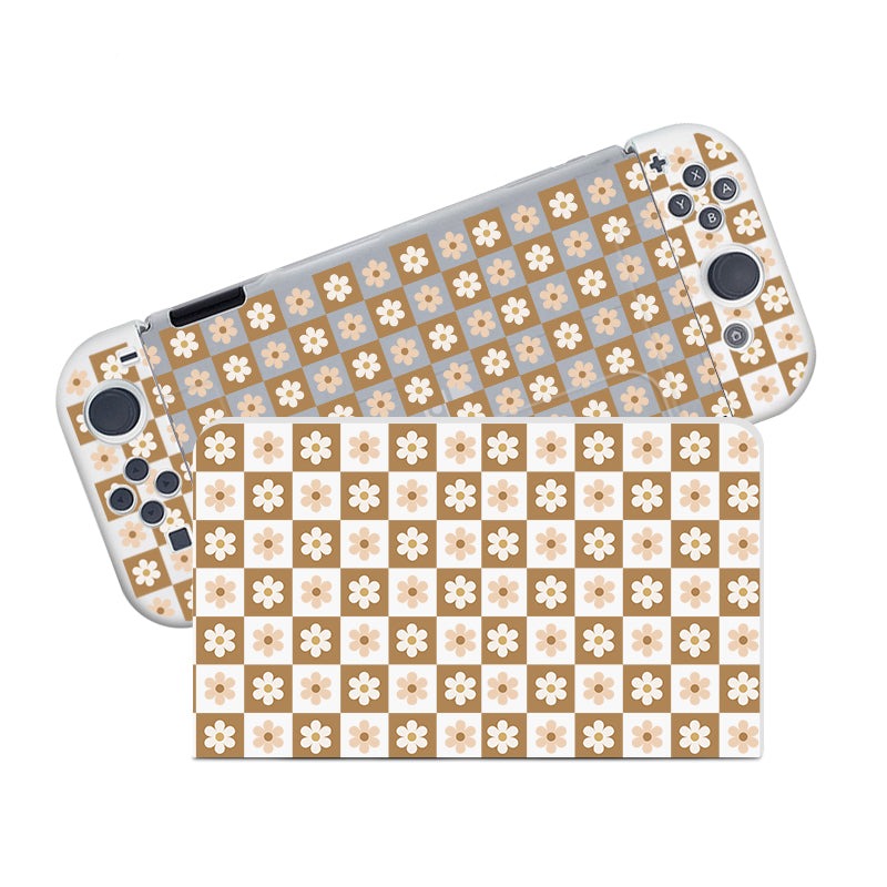 A Nintendo Switch with the petimint Cozy Checkered Flowers Case is displayed. The semi-clear case, made from soft TPU material, features a checkered pattern with alternating brown and beige squares, each adorned with white flower designs. The console's buttons and joysticks are visible.