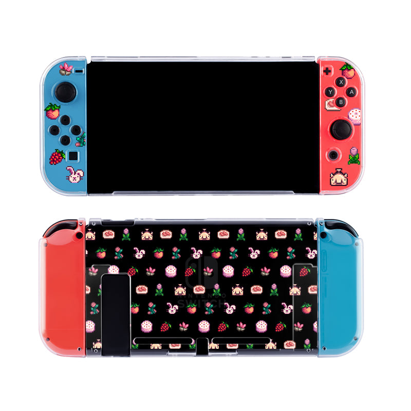 A Nintendo Switch tailored for the cozygamer features blue and red Joy-Cons with a custom design. The left Joy-Con sports fruit and animal stickers, while the right showcases strawberries, flowers, and animals. The back has a black background adorned with the same whimsical pattern of stickers and is protected by a Pink Stardew Items Case from petimint in clear color.