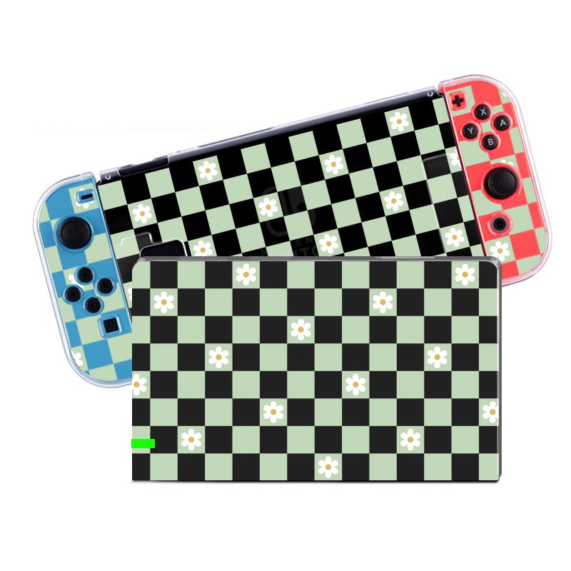 The Checkered Flowers Case for Nintendo Switch by petimint, featuring red and blue controllers, is placed behind a handheld device. Both boast a classic gamer aesthetic with a chessboard pattern of alternating black and light green squares. Some green squares are adorned with small white flower designs in the center.