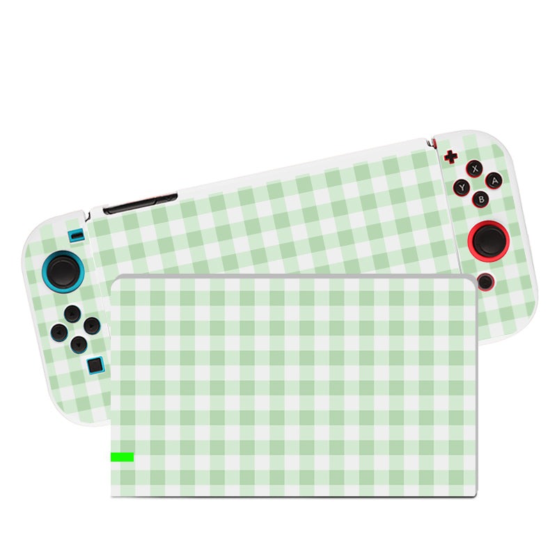 Introducing the Picnic Case for Nintendo Switch by petimint—a light green and white checkered design that’s perfect for any cozygamer looking to elevate their gaming setup. The detachable controller features multi-colored buttons and joysticks, while the main console body is adorned with the same charming checkered pattern.