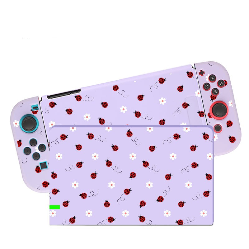The petimint Little Ladybug Case for Nintendo Switch is a whimsical accessory with detachable controllers, adorned in a lilac skin featuring a pattern of ladybugs and white flowers. The controller buttons remain fully visible, making it the perfect choice for any cozygamer seeking a unique touch to their Nintendo Switch.