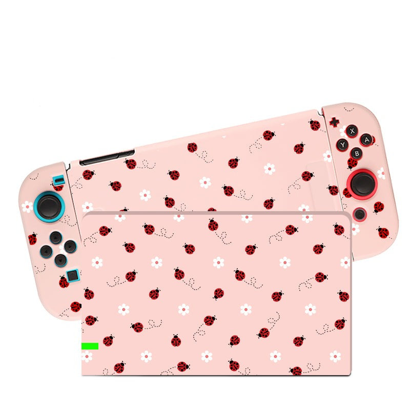 The Little Ladybug Case for Nintendo Switch by petimint is a handheld gaming console with detachable controllers, featuring a pink skin adorned with red ladybugs and small white flowers. Perfect for the cozy gamer, the buttons and controls are conveniently visible on the controllers.