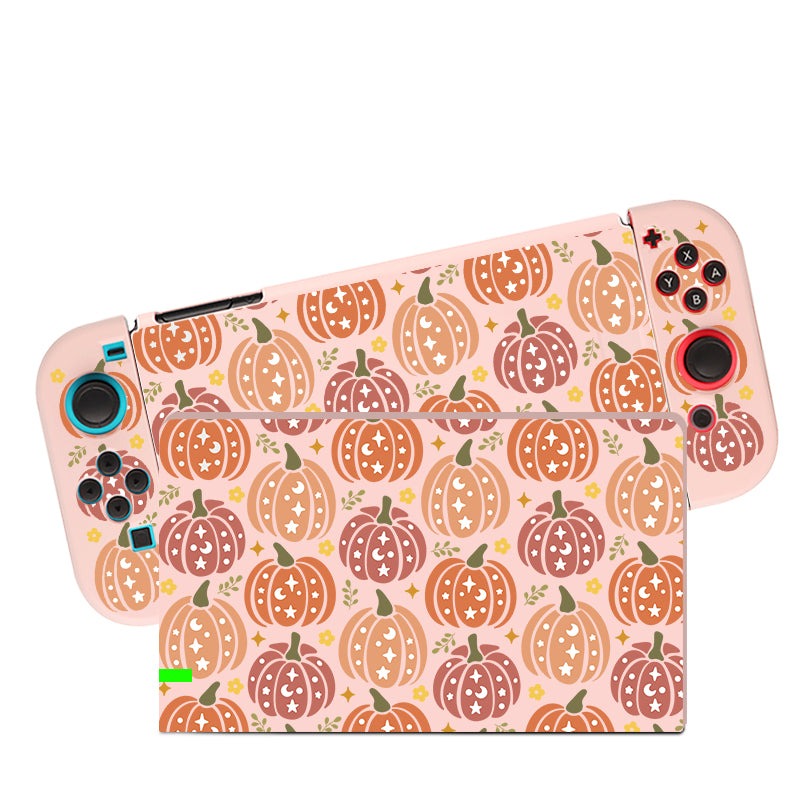 A Nintendo Switch encased in the "Pumpkins Case for Nintendo Switch" by petimint is displayed. Both the console and its detachable controllers are adorned with a colorful pumpkin pattern set against a light pink background, creating a festive autumn theme perfect for any gamer. The buttons and thumbsticks remain clearly visible.