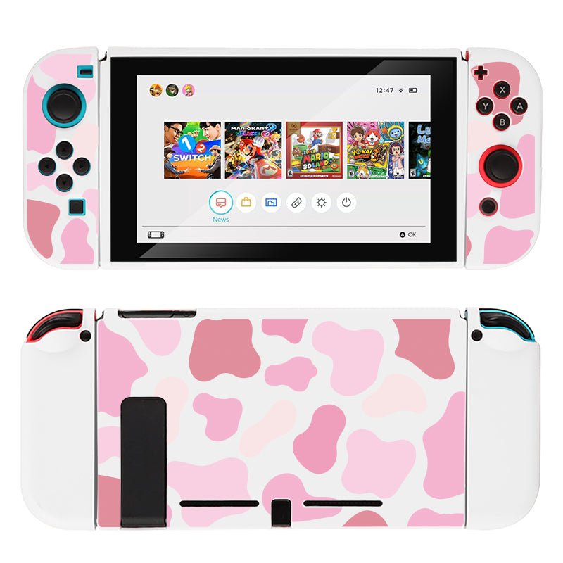 A Nintendo Switch with a pink and white camouflage-patterned casing and controllers, featuring the Strawberry Cow Case from petimint, enhanced by a soft TPU switch grip case. The screen displays a game menu adorned with vibrant, colorful icons.