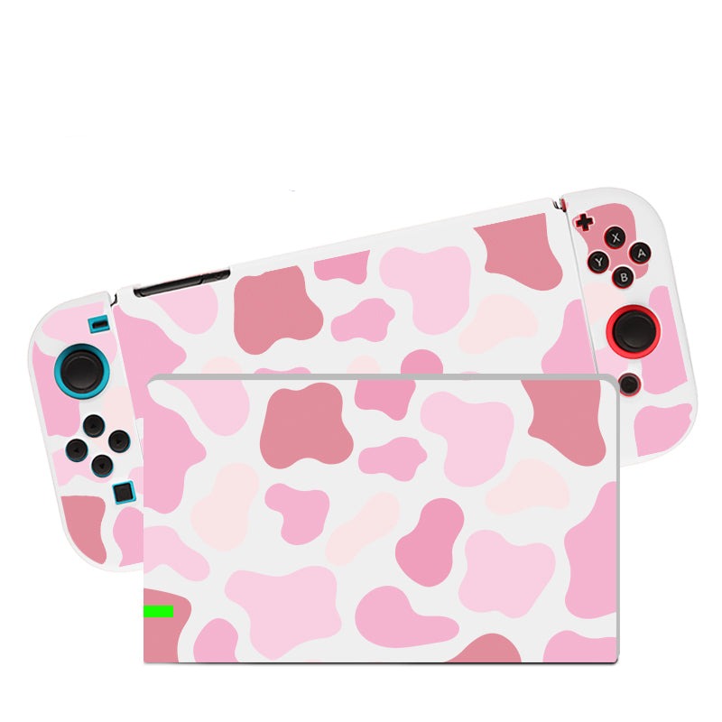 Introducing the Strawberry Cow Case by petimint, designed for your Nintendo Switch. This gaming console case features a vibrant pink and white cow print with detachable controllers. The soft TPU finish provides enhanced protection and comfort, with blue buttons on the left controller and red buttons on the right. Keep your style intact both while charging and on the go, thanks to its convenient dockable design.