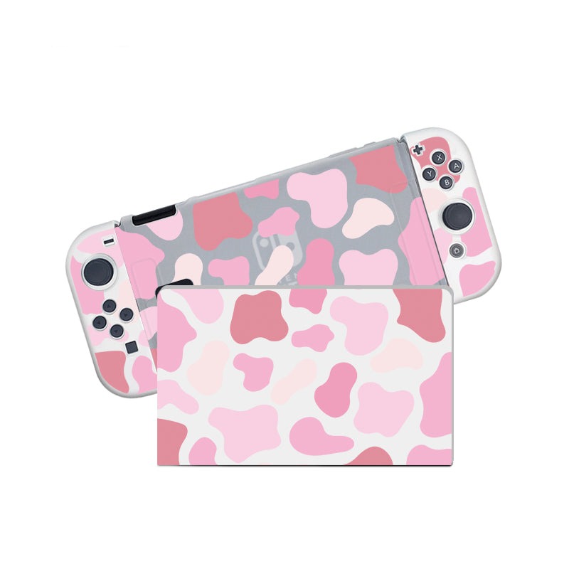 The Strawberry Cow Case for Nintendo Switch by petimint is showcased, featuring detachable controllers encompassed in a soft TPU, dockable case. The console is adorned with a pink and white camouflage pattern that incorporates various shades of pink, elegantly covering both the main console and the controllers.