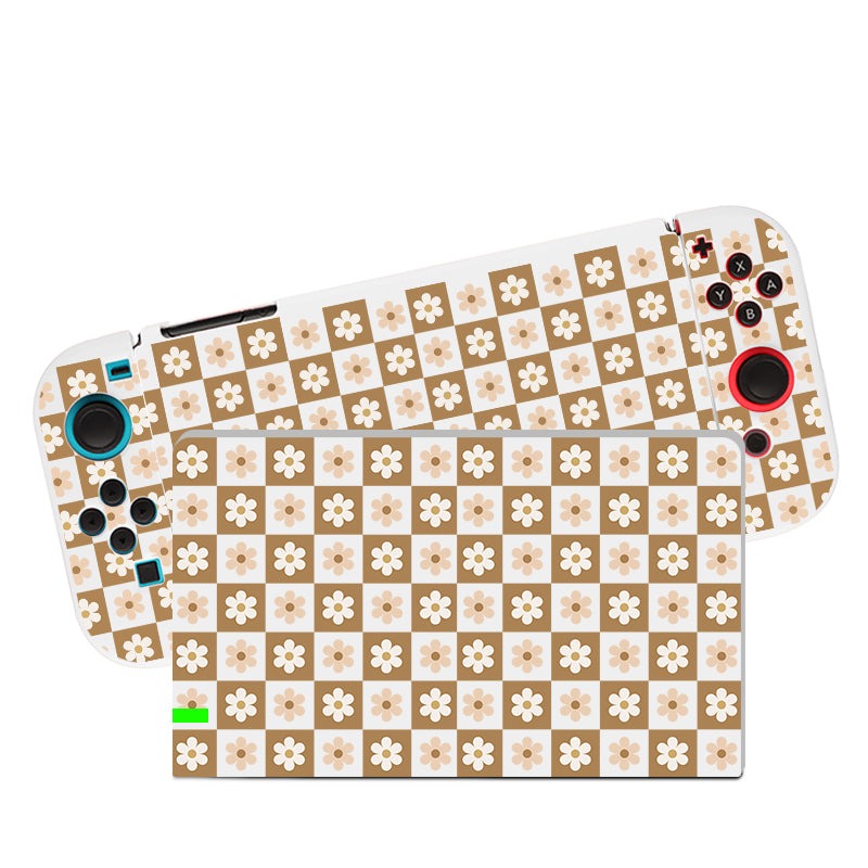 Introducing the Cozy Checkered Flowers Case for Nintendo Switch by petimint, a gaming console adorned with a retro-themed floral skin made from soft TPU material. This elegant case features a checkered pattern with brown and beige squares, each beautifully accented with small white flowers. The console's design includes various control buttons and joysticks for an optimal gaming experience.