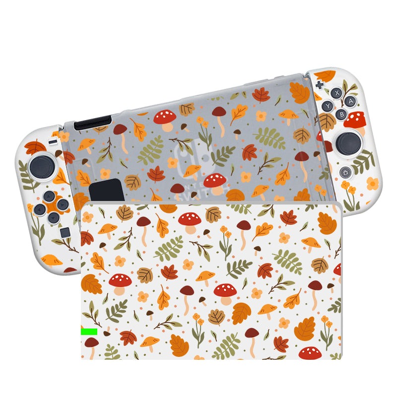 The Cozy Autumn Case for Nintendo Switch by petimint is a handheld gaming console case adorned with an autumn-themed design showcasing leaves, mushrooms, and acorns in vibrant orange, red, and green tones against a crisp white and pale blue backdrop. The dockable semi-clear case not only offers robust protection but also flaunts the same seasonal motif, blending functionality with style.