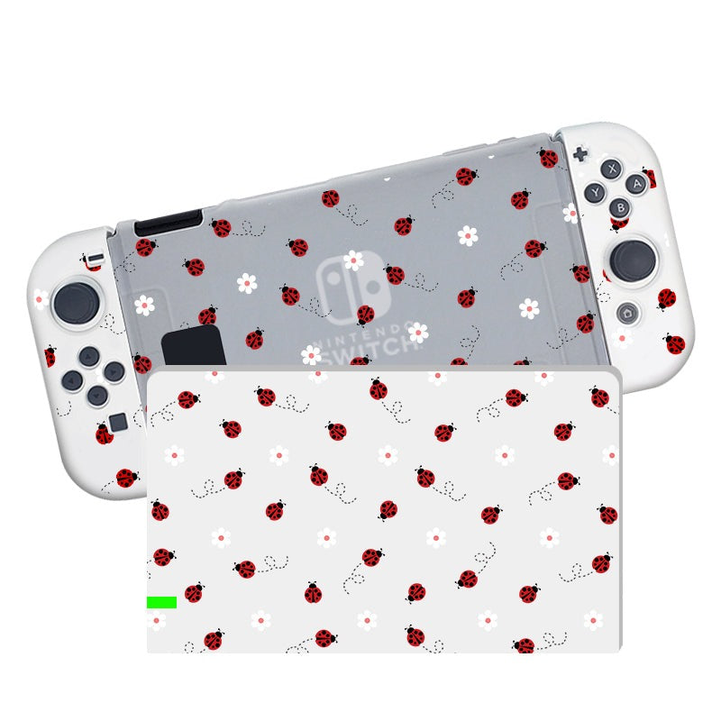 A Nintendo Switch console encased in the petimint Little Ladybug Case, showcasing a semi-clear gray background adorned with a delightful ladybug and white flower pattern. The same charming design is displayed on the screen. The controllers, designed with soft TPU for comfort, feature white borders and gray buttons.