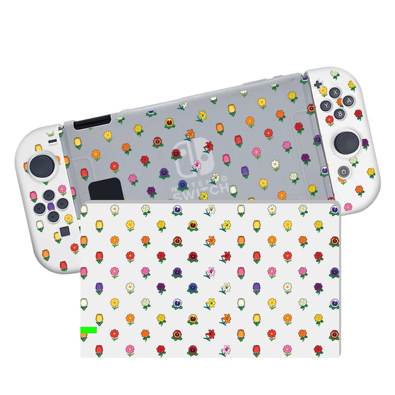 A Nintendo Switch and controller from petimint’s Flower Crossing Case collection, featuring a semi-clear, soft TPU dockable case with a pattern of colorful, small flower icons. The console is positioned screen-down, while the controller's buttons and joysticks remain visible. The flower icons are diverse in color and design.