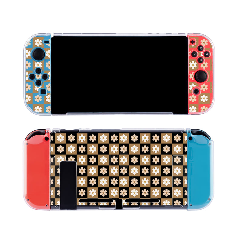 The petimint Cozy Checkered Flowers Case for Nintendo Switch showcases a pair of Joy-Con controllers adorned with custom floral designs. The left Joy-Con boasts a blue and gold floral pattern, while the right Joy-Con displays a red and gold floral pattern. Both controllers are enclosed in a clear, dockable case made from soft TPU material, ensuring both style and protection.