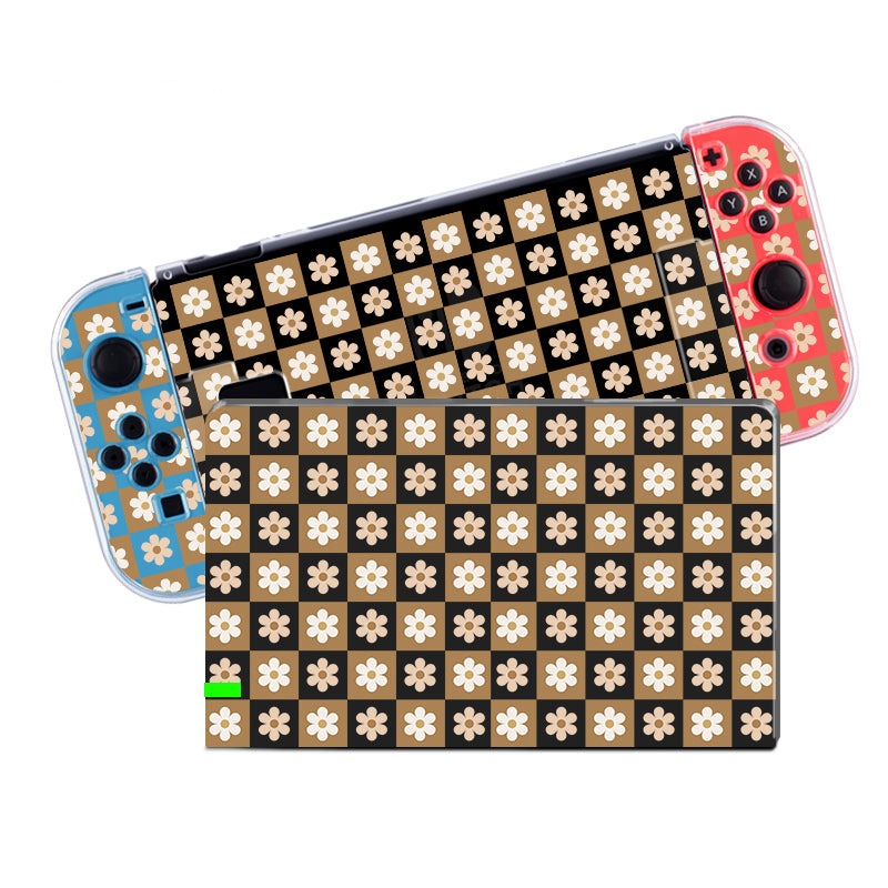 The petimint Cozy Checkered Flowers Case for Nintendo Switch features blue and red controllers on the sides, complemented by a black cover adorned with a beige and white floral pattern. Crafted from durable soft TPU material, the dockable case offers both protection and style. The console screen and controller skins match this elegant floral design, creating a cohesive look.