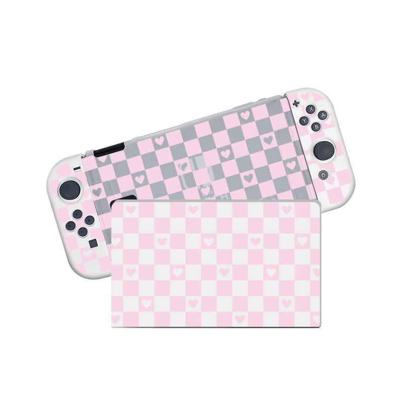 A semi-clear Checkered Love Case for Nintendo Switch, crafted by petimint, showcases a pink and gray checkered pattern adorned with small pink hearts. Perfect for the cozygamer, the handheld console is displayed with one controller slightly detached, revealing the back part of its case.