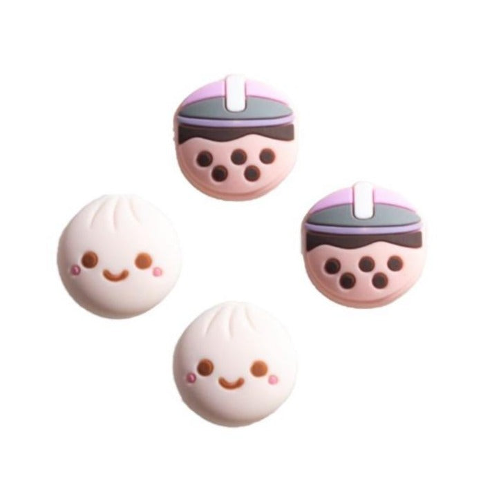 Add a fun and playful touch to your gaming experience with the petimint Blubble Tea Thumb Grips for Nintendo Switch. This set includes four adorable dumpling-shaped joystick caps featuring smiling faces: two designed like traditional dumplings and two wearing hats that mimic a stylized bubble tea cup, all in pastel colors.