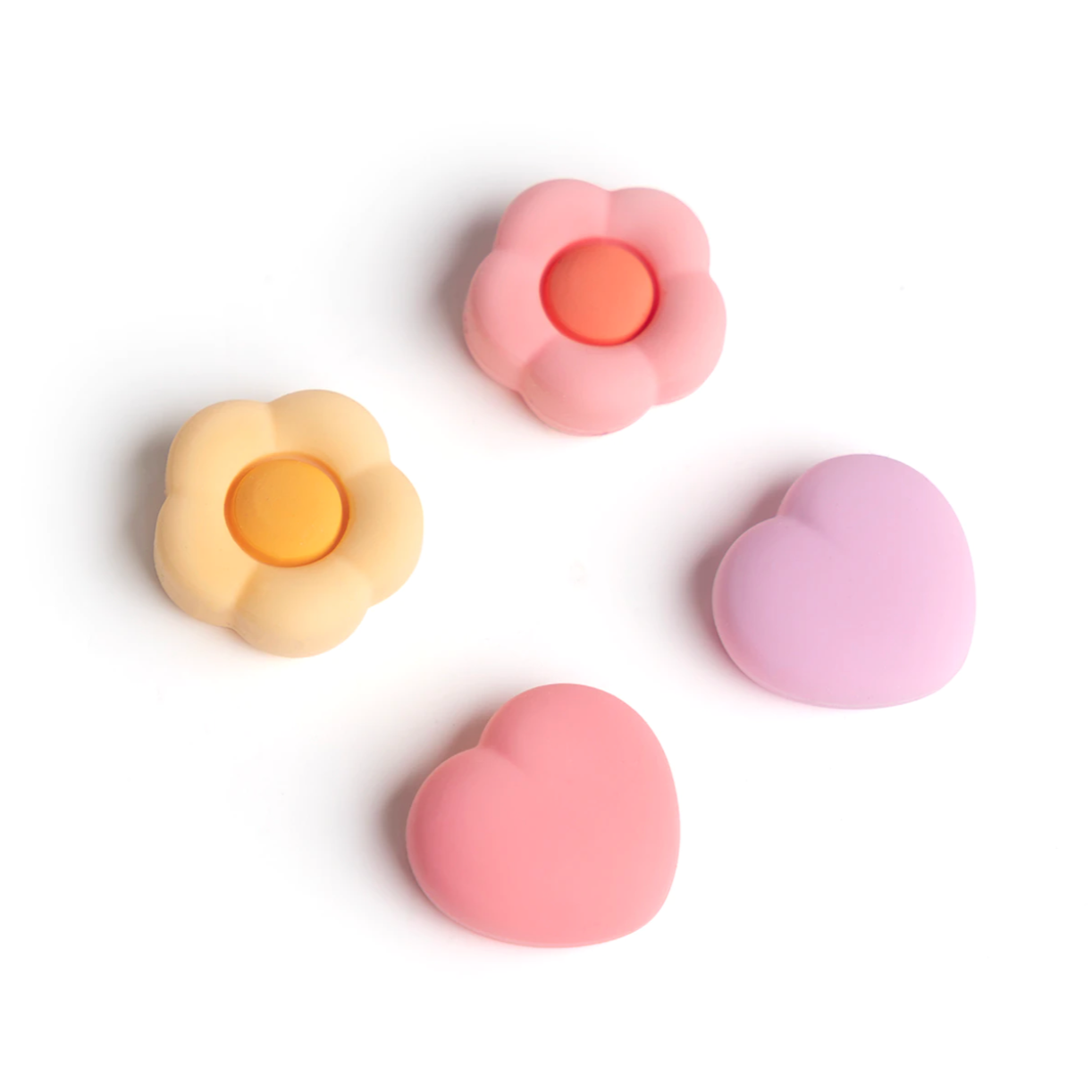 On a white background, four silicone containers are showcased: two flower-shaped in pink and yellow, and two heart-shaped in pink and lavender. These containers perfectly complement the petimint Blue Love Flowers Thumb Grips for Nintendo Switch, enhancing your gaming experience with vibrant colors.