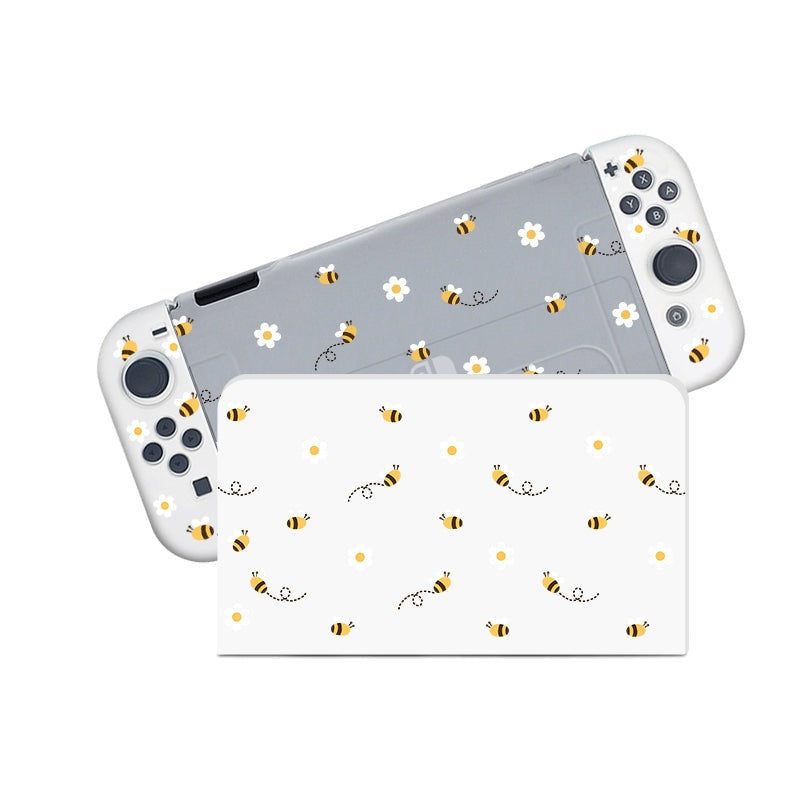 The Little Bee Case for Nintendo Switch by petimint features a handheld gaming console adorned with playful bee and daisy flower patterns on its protective case, making it perfect for the cozygamer. The console boasts white grips and buttons, while the cheerful bees and daisies are evenly scattered across the entire case.